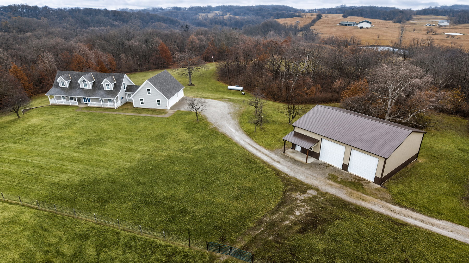 Kansas City luxury acreage home with outbuilding aerial view in daylight - MoJo Real Estate Team